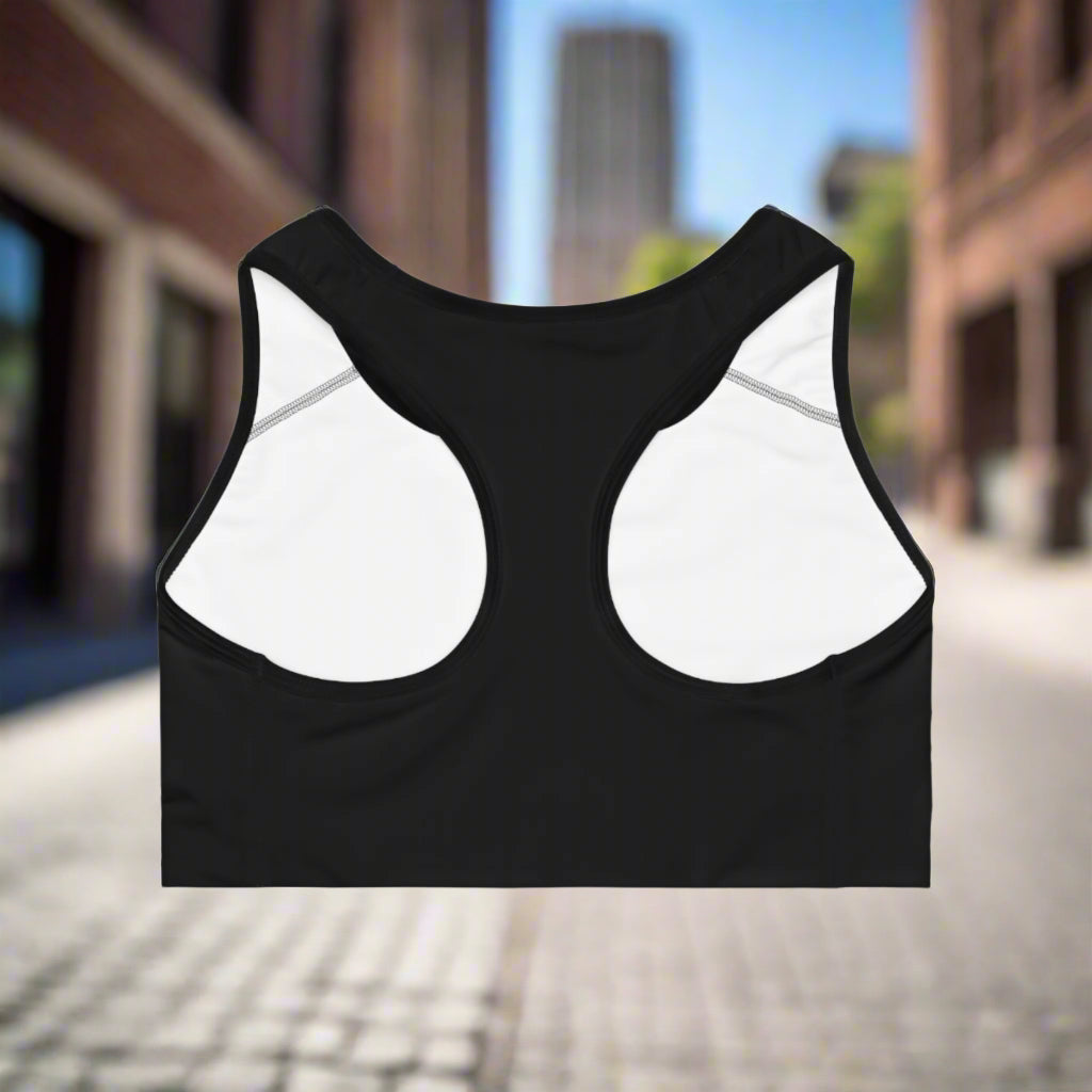 Black sports bra with white mesh panels on a white background
